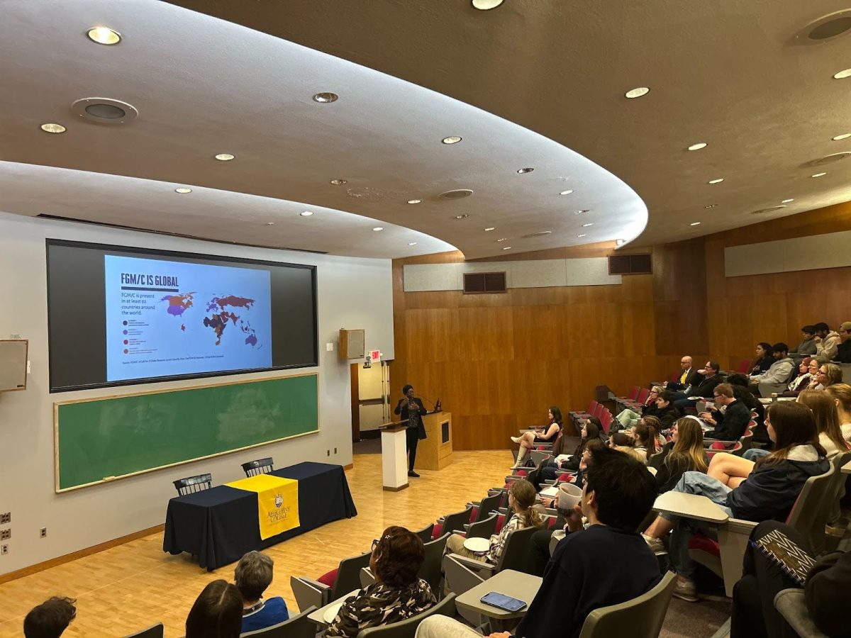 Assistant Professor of Economics Aisha Yusuf explains the global impact of female genital mutilation to audience members in Quigley Hall on March 12.