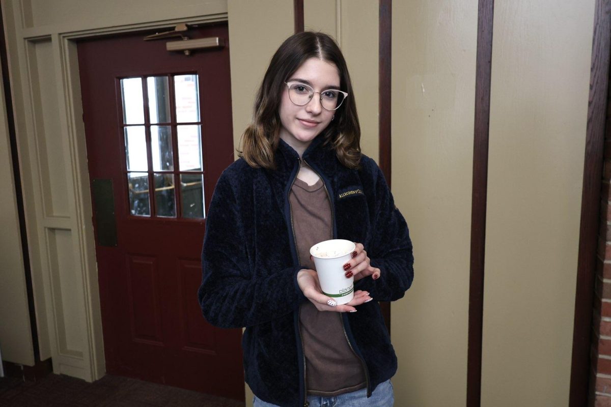 Niki Hineman, '29, holds a cup of hot chocolate in Crawford Hall, where she lives. 