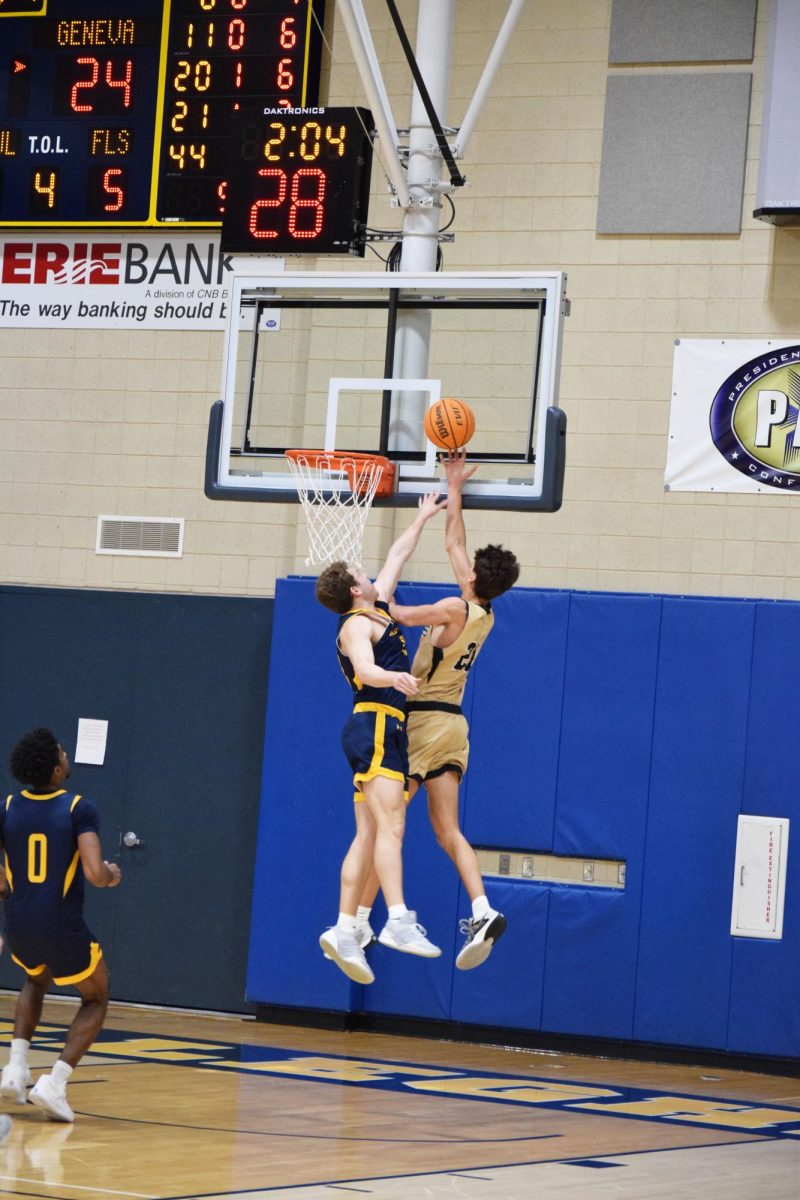 Lang leaps to block a shot from a Geneva player.