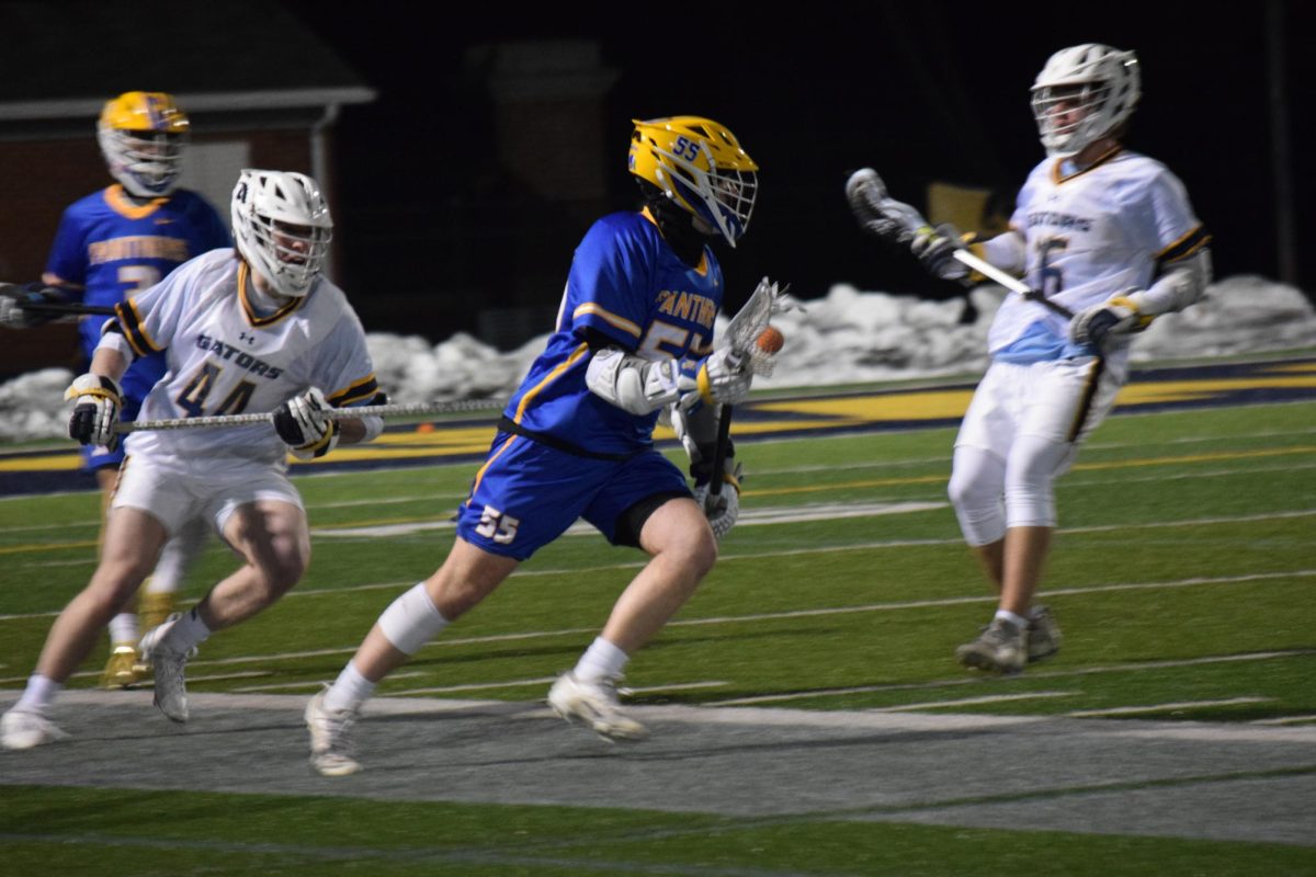 A Pitt-Bradford player races down the field with defender Jared Swisher, ’26, in hot pursuit.
