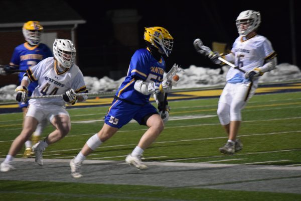 A Pitt-Bradford player races down the field with defender Jared Swisher, ’26, in hot pursuit.