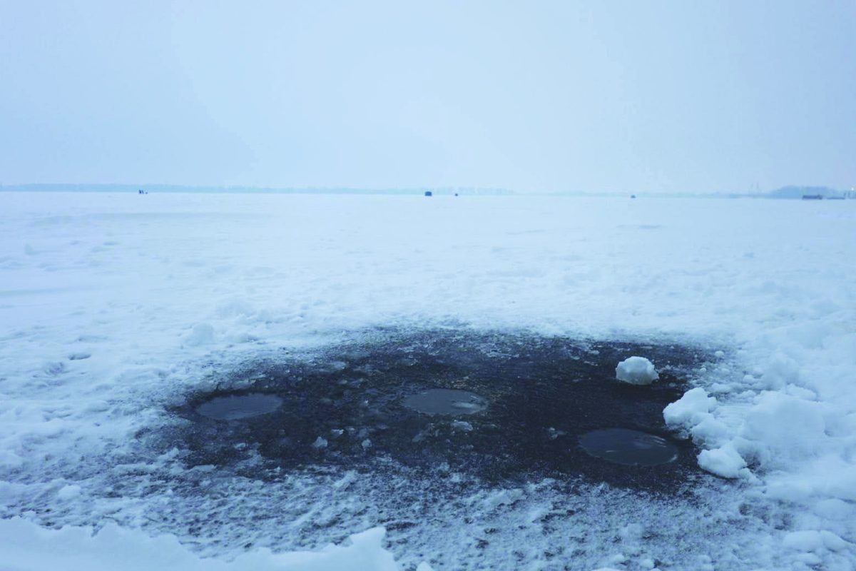Nearly three-quarters of a mile out on Lake Erie, multiple ice fishing holes sit as evidence of residents’ interactions with the nearly-frozen lake on Saturday, Feb. 7.