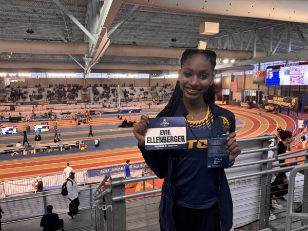 Evie Ellenberger, ’28, poses with her nametag at the NCAA Indoor Championships on Friday, March 13.