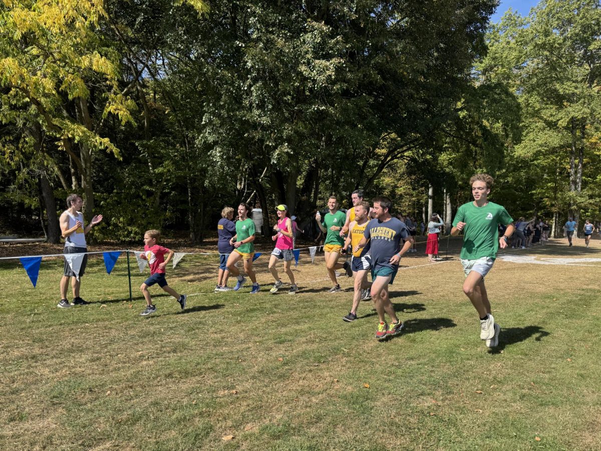 Runners cross the finish line of the Mourer Mile. The mile was open to anyone who wanted to participate in memorium of the late coach Ben Mourer, ‘07.