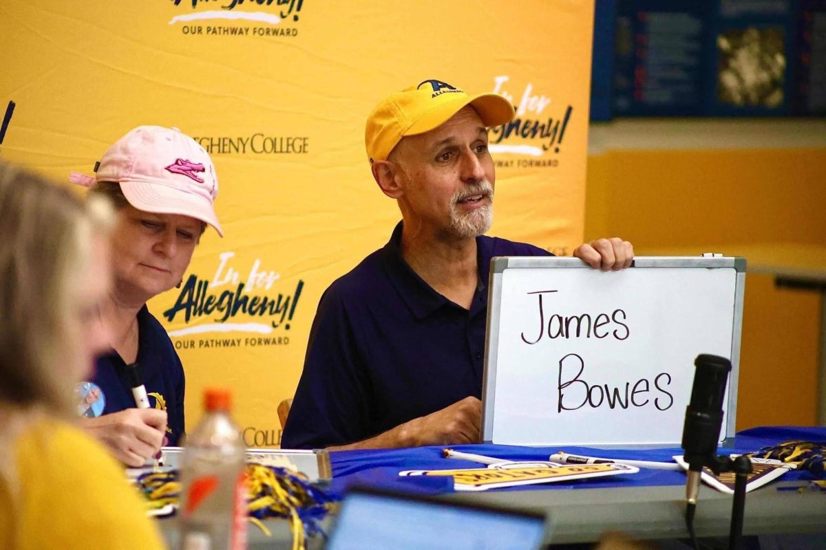 Allegheny President Ron Cole, ’87, holds up a sign of a donor's name during a livestream on Thursday, April 16.